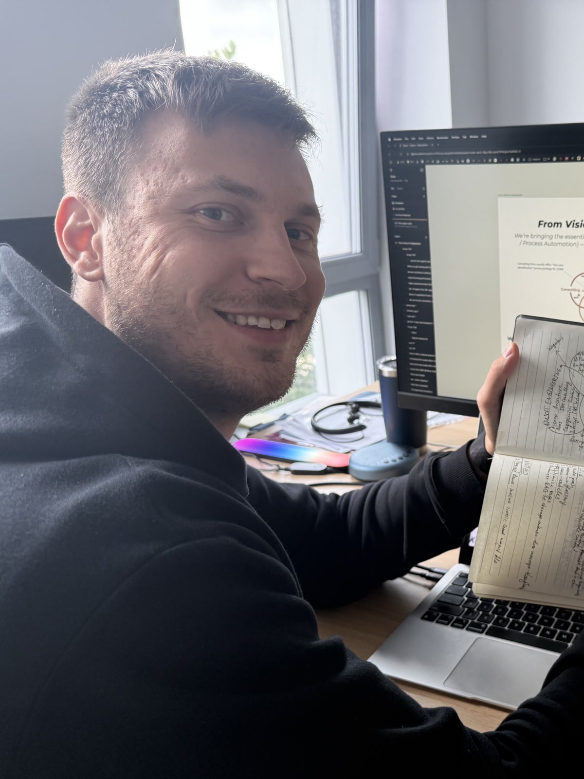Antoni Kozelski working through an architecture sketch in a notebook